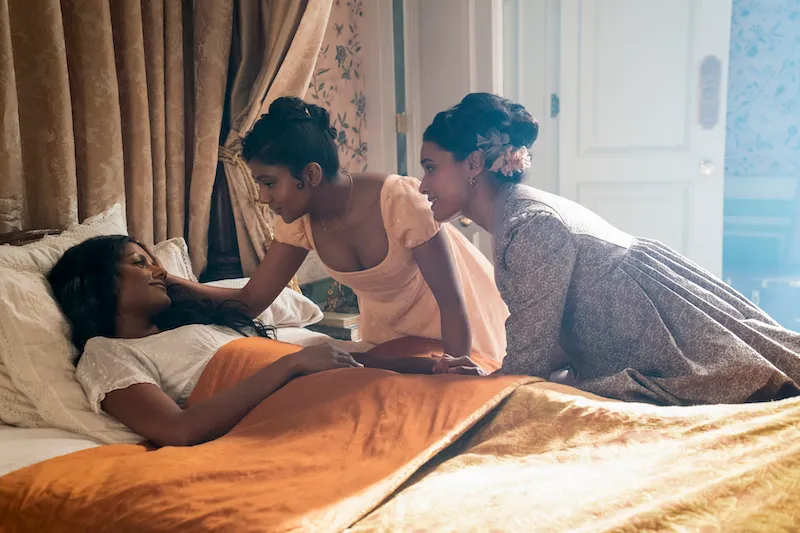 Bridgerton. (L to R) Simone Ashley as Kate Sharma, Charithra Chandran as Edwina Sharma, Shelley Conn as Mary Sharma i...