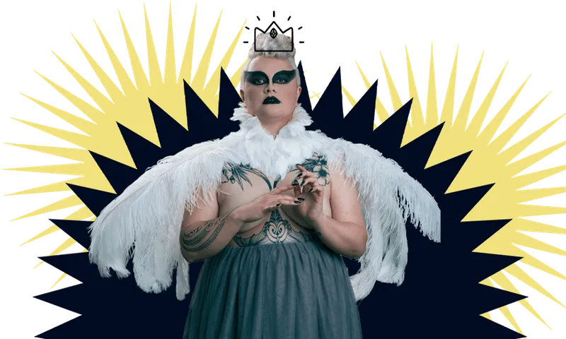 Photograph of woman wearing magnificent costume of white feathers and grey gauze. Dramatic makeup.
