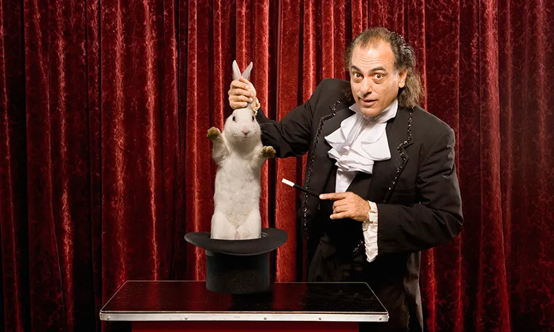 Magician pulling a rabbit out of a hat