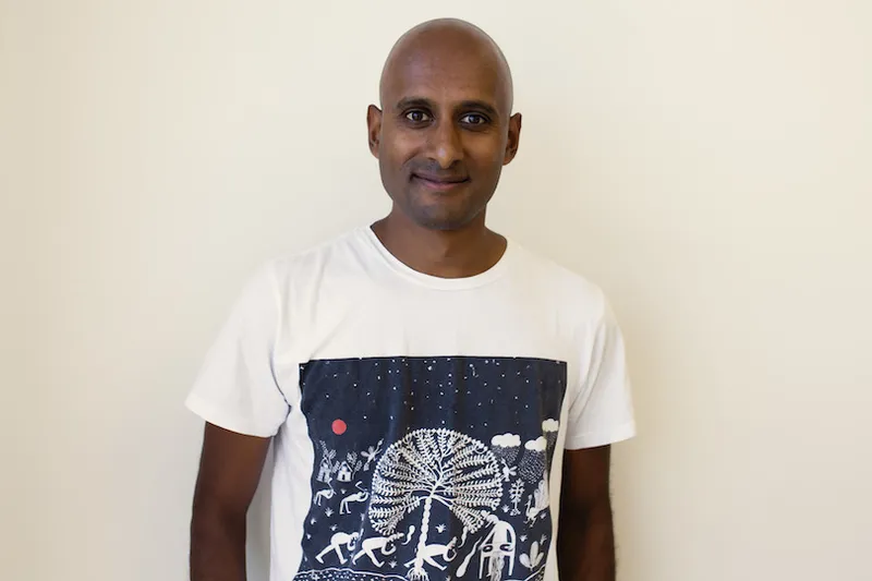 Photograph of middle-aged man wearing white printed T.
