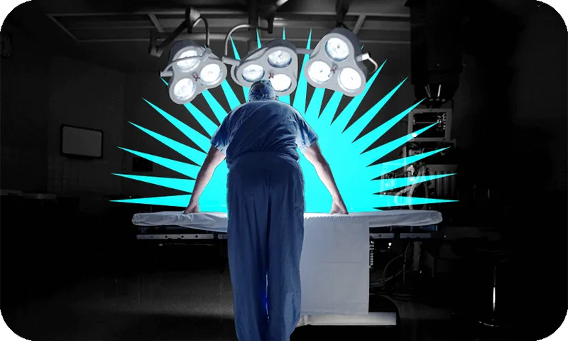 Back view of a surgeon leaning over an empty surgery table