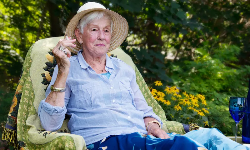 Happy senior woman smoking marijuana joint as cannabis medicinal