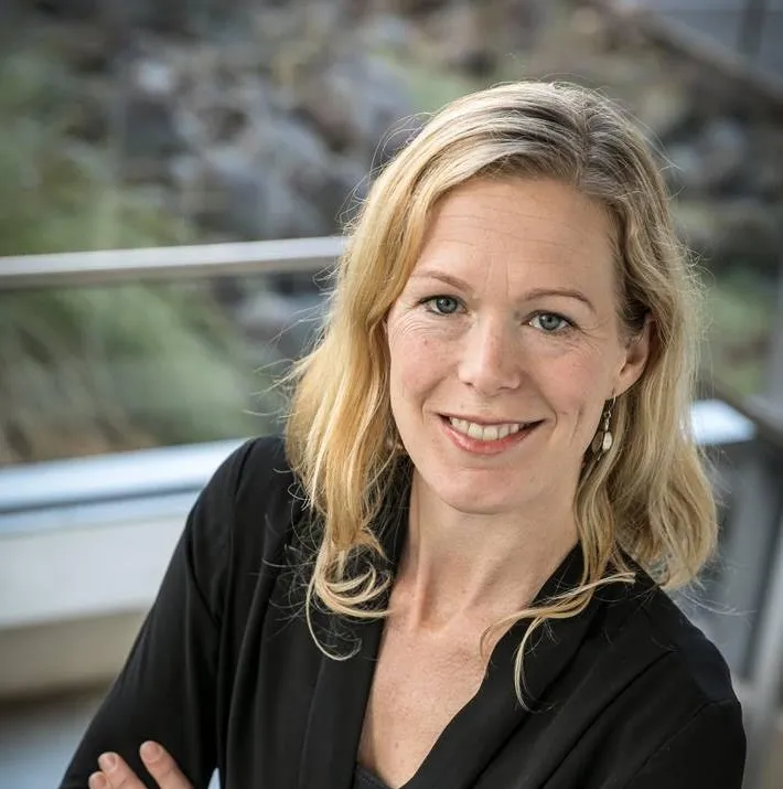 Holly thorpe, a smiling white woman, looks at the camera