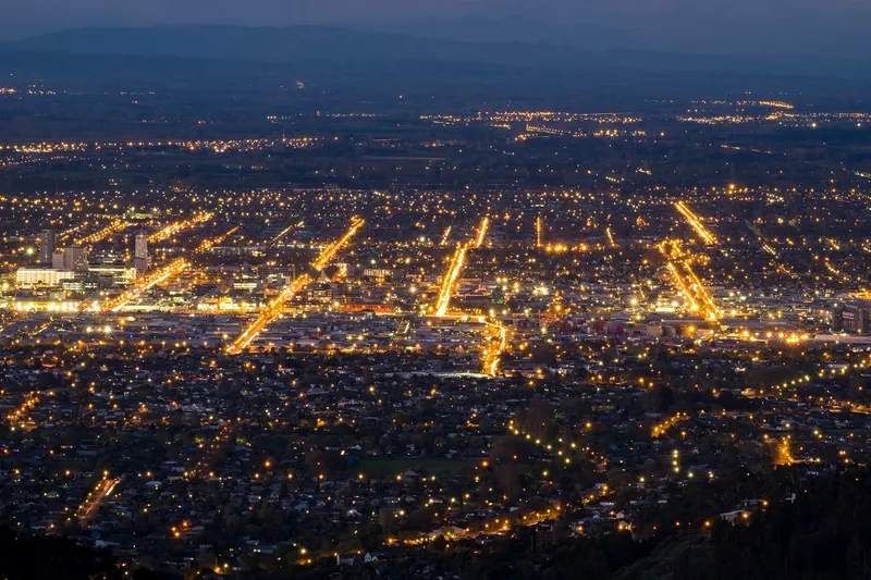 lines of light show the location of streets. hazy dark sky and light pollution