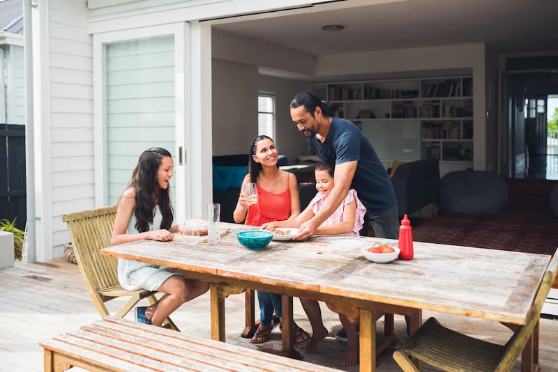 Father serving food to family.