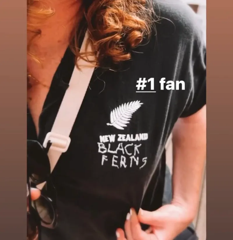 A fan wears a hand-stitched Black Ferns jersey