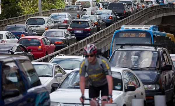 cars, cyclist and bus in auckland