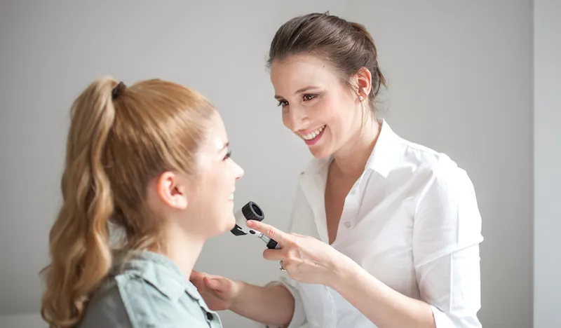 Dermatologist Inspecting Patient Face Skin with Dermatoscope