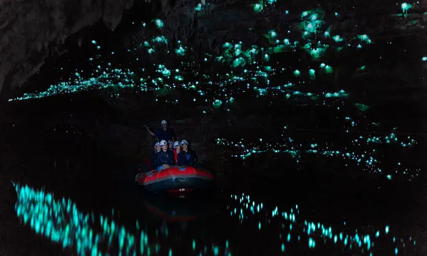 Tourists looking at famous glowworm cave, Waitomo caves, New Zealand