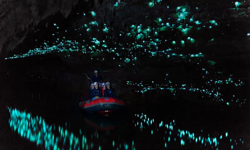 Tourists looking at famous glowworm cave, Waitomo caves, New Zealand