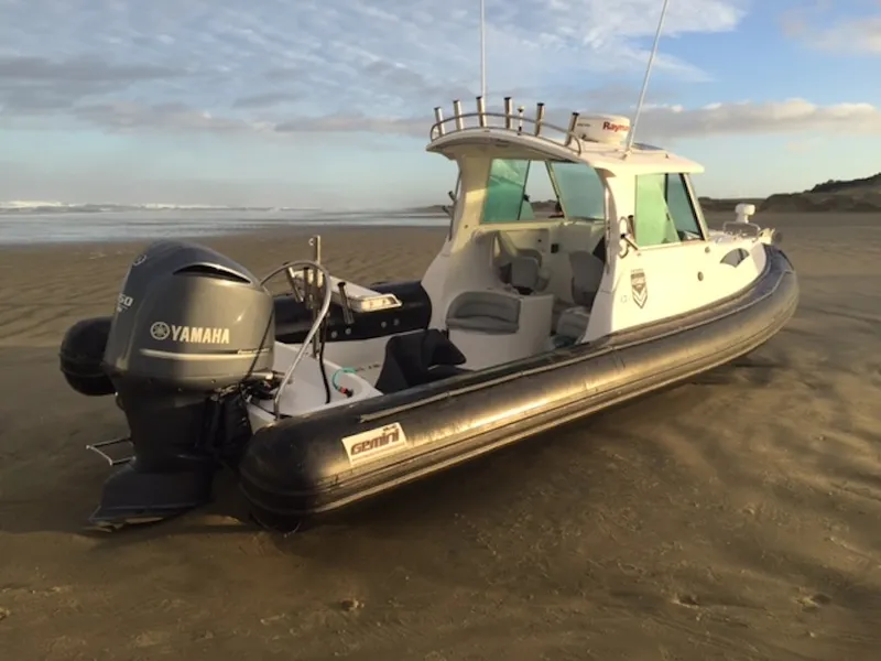 A inflatable boat pulled up on a beach.