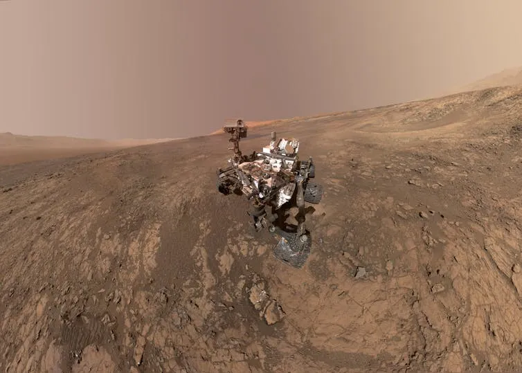 NASA's Curiosity Mars rover on Vera Rubin Ridge, with Mt Sharp in the background.