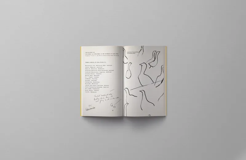 An open book, sketches of geese on one page, text on the other