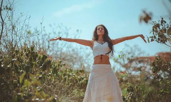 a woman meditating in a field
