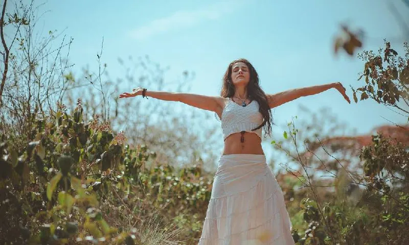 a woman meditating in a field