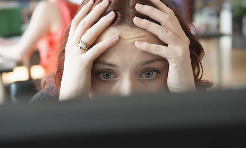 Frustrated woman using computer