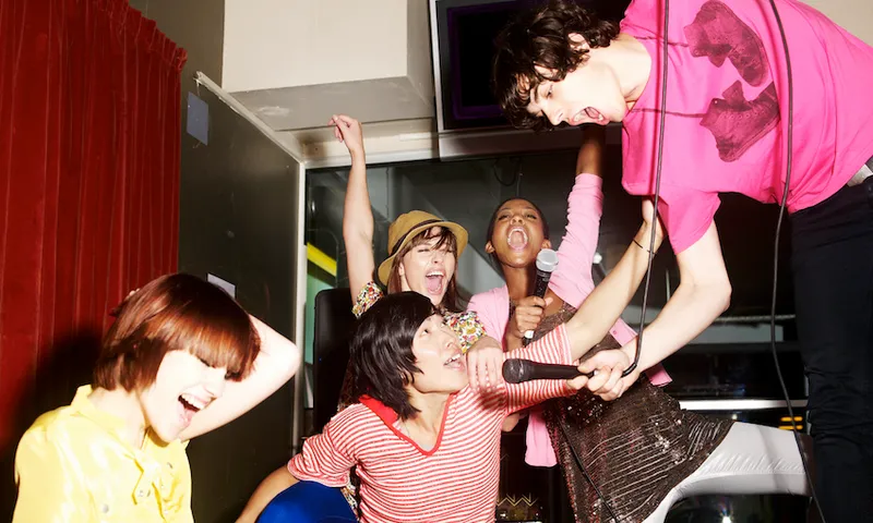 Friends singing in karaoke club