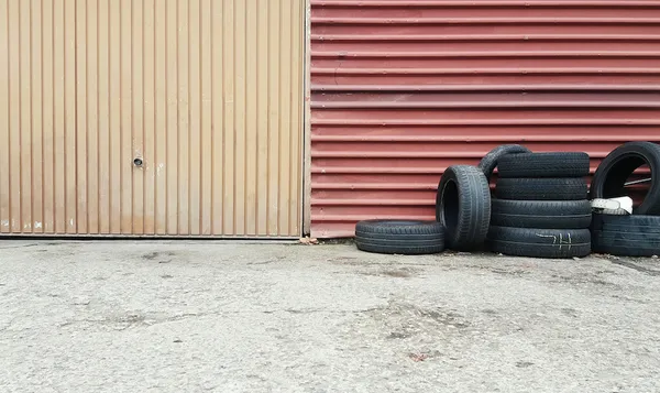 Tires Against Metallic Wall