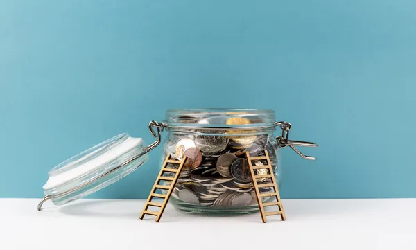 Ladders lent against jar of coins