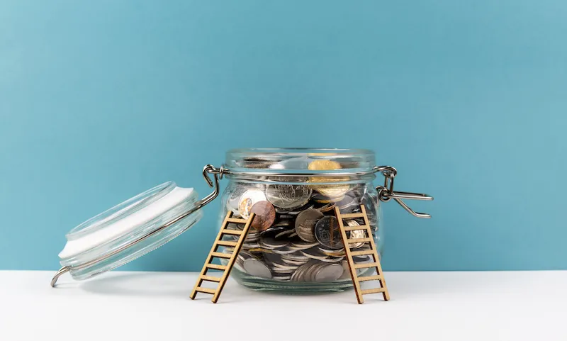 Ladders lent against jar of coins