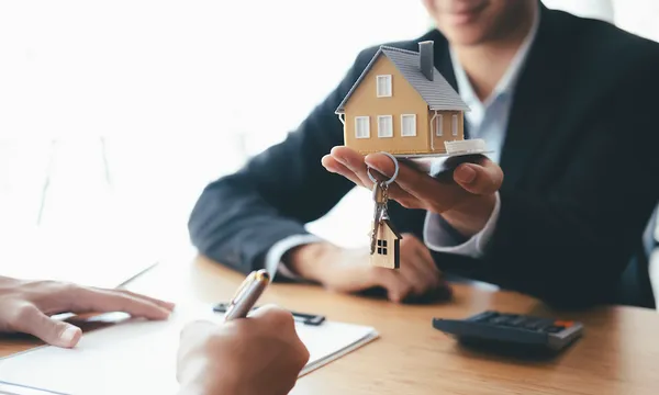 Customer signing contract for a new house.