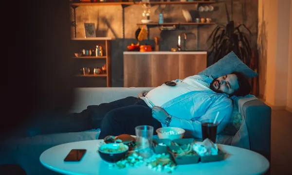 guy sleeping in front of the tv getty
