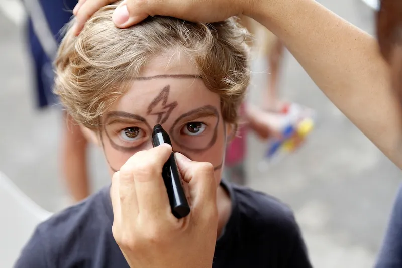 Boy having face painted