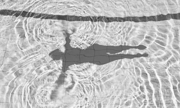 Shadow of Woman Floating on the Water