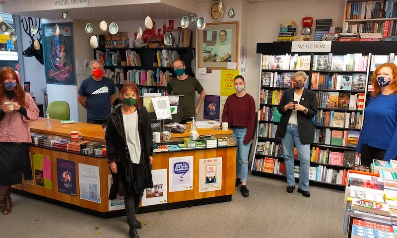 A bookstore, with seven masked staff standing facing camera