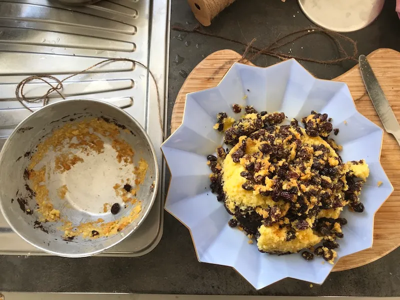 A collapsed steamed pudding, raisins all over the place.