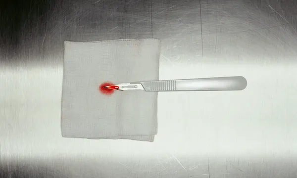 Scalpel with blood
