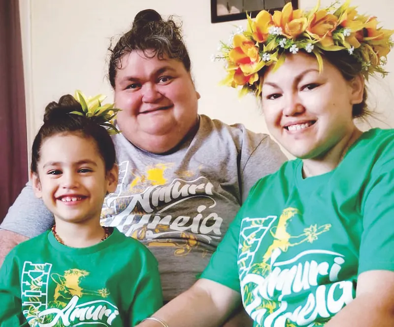Photo of a little girl, a middle-aged woman and a young woman, all very happy.