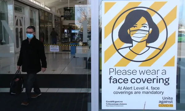 A sign is seen inside a mall advising people to wear face