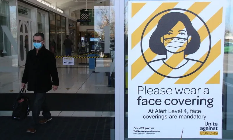 A sign is seen inside a mall advising people to wear face