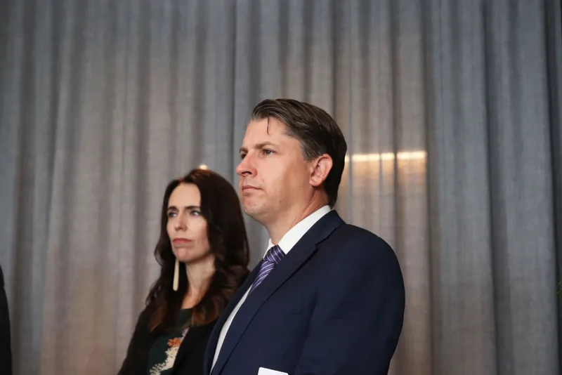 Michael Wood and Jacinda Ardern standing together