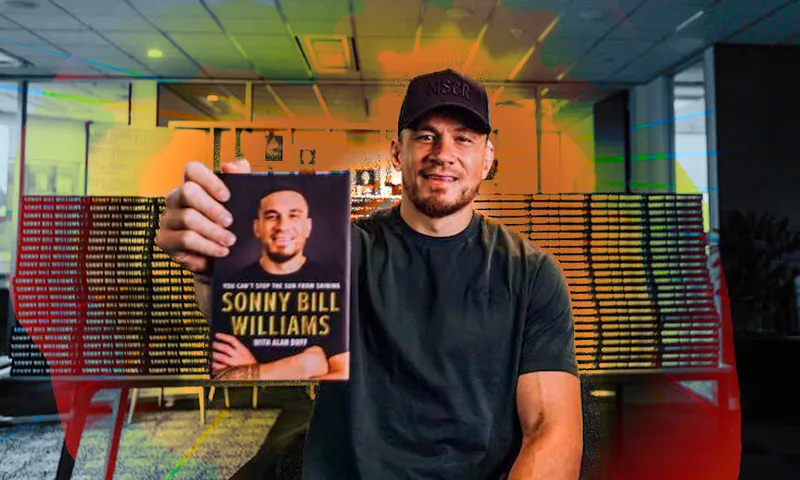 Sonny Bill Williams holding his autobiography, You Can’t Stop the Sun from Shining