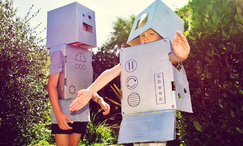 Two children dressed as cardboard-box robots