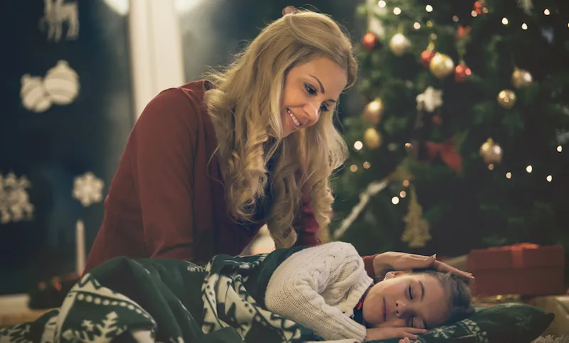 Daughter waiting for Santa, sleeping on the floor