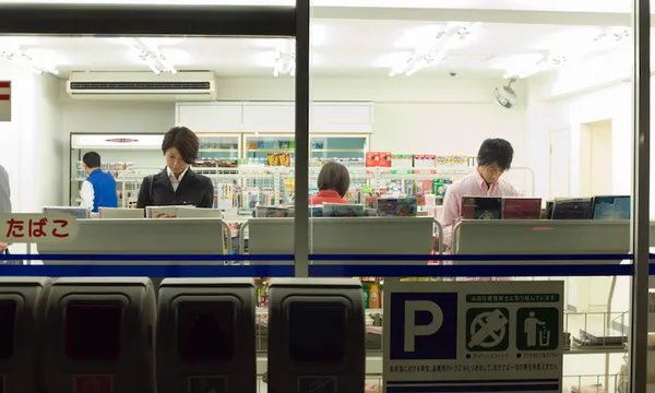 People reading magazines at convenience store