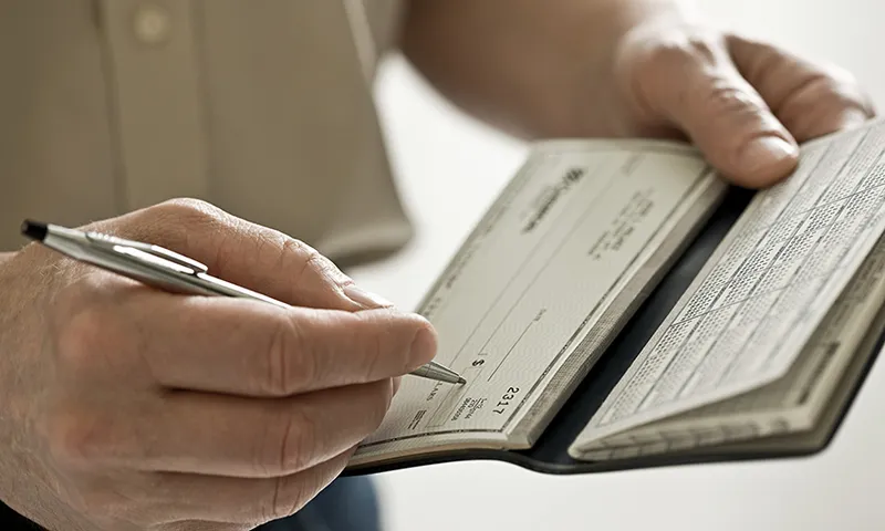 A man holding a cheque book