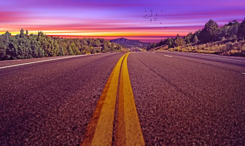 road-descending-into-sunrise-sunset