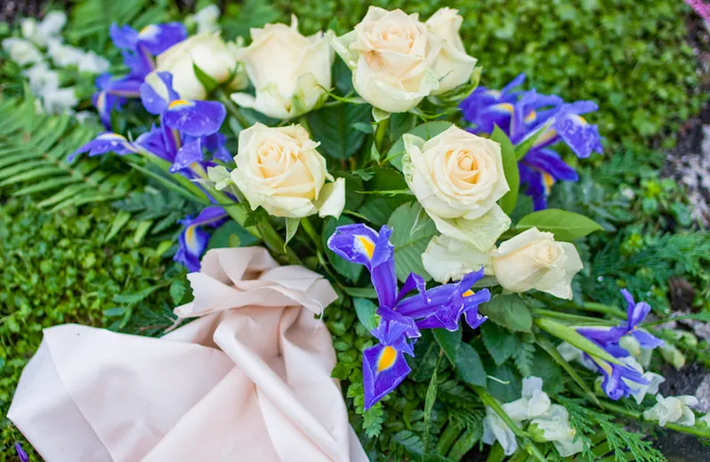 Silk flowers on a gravestone, Flowers on a cemetery