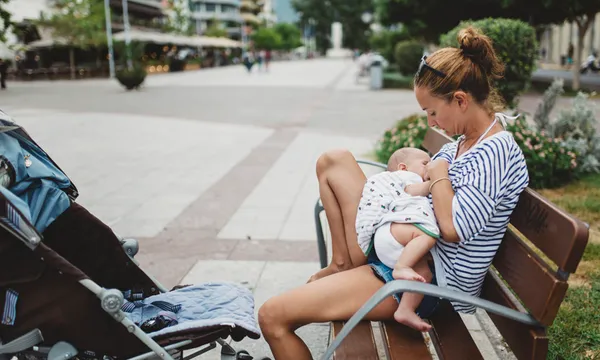 Mother breastfeeding her baby outdoor