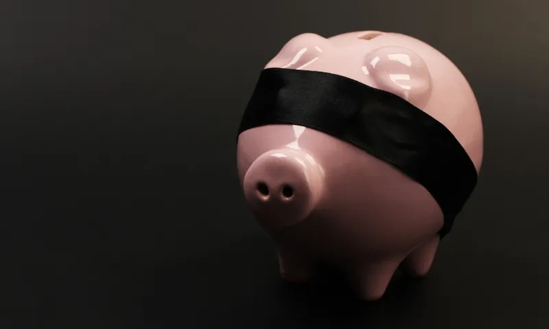 blindfolded piggy bank getty