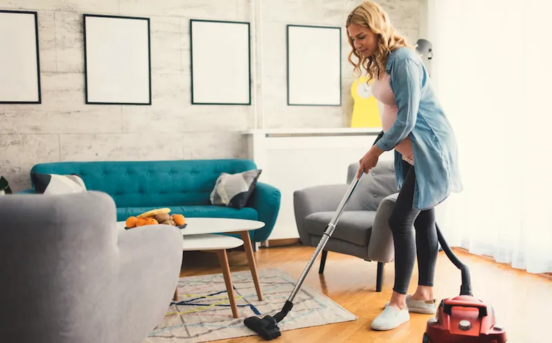 Pregnant Woman Vacuuming carpet