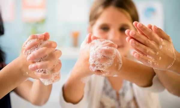 Girls washing hands with soap
