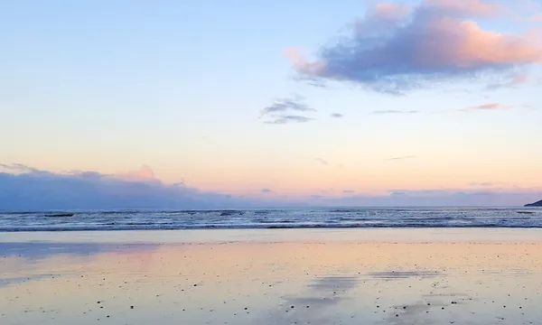 Scenic View Of Beach Against Sky During Sunset