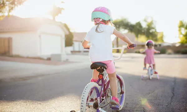 Young Girls Riding Bikes