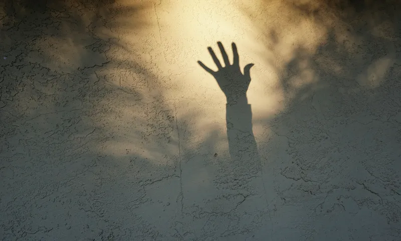 Shadow of a hand reaching up
