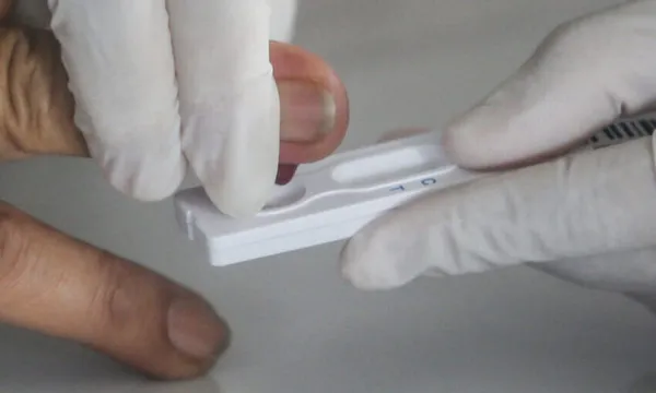 A man is being tested for COVID-19 by a health official with